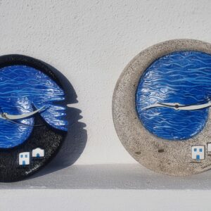 Two blue wave-shaped decorative wall clocks
