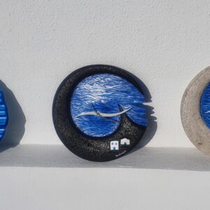 Three blue wave-themed decorative wall clocks