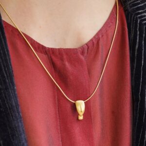 Gold necklace with minimalist face pendant