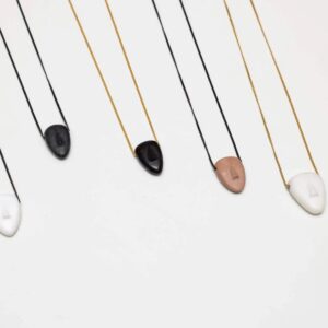 Minimalist stone pendant necklaces on white background