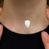Minimalist white face pendant on gold necklace