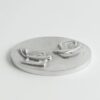 Round silver plaque with two raised lizards