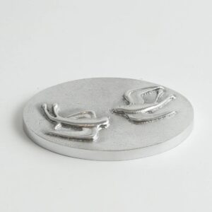 Round silver plaque with two raised lizards