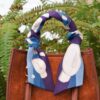 Brown handbag with patterned scarf on handle