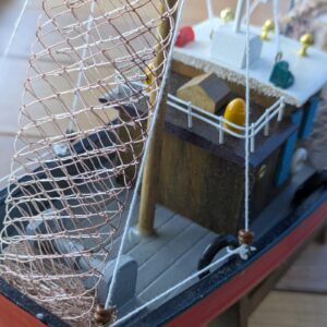 Close-up of model fishing boat with net