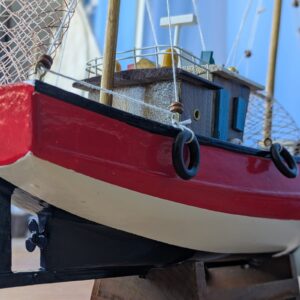 Close-up of a colorful model fishing boat