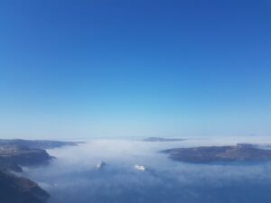 Cruise ships in foggy coastal caldera