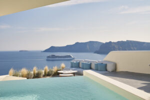 Infinity pool overlooking sea with cruise ship