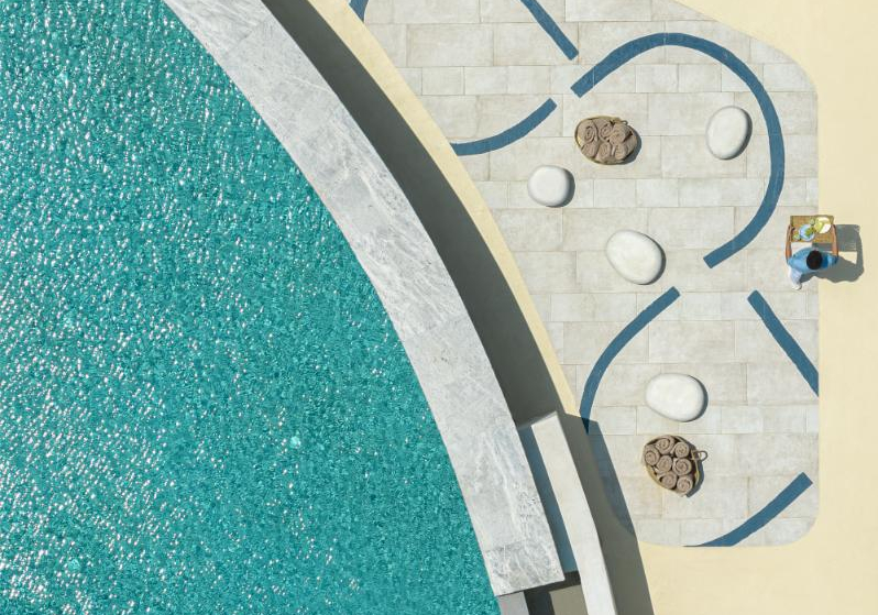 Aerial view of curved pool and tiled deck