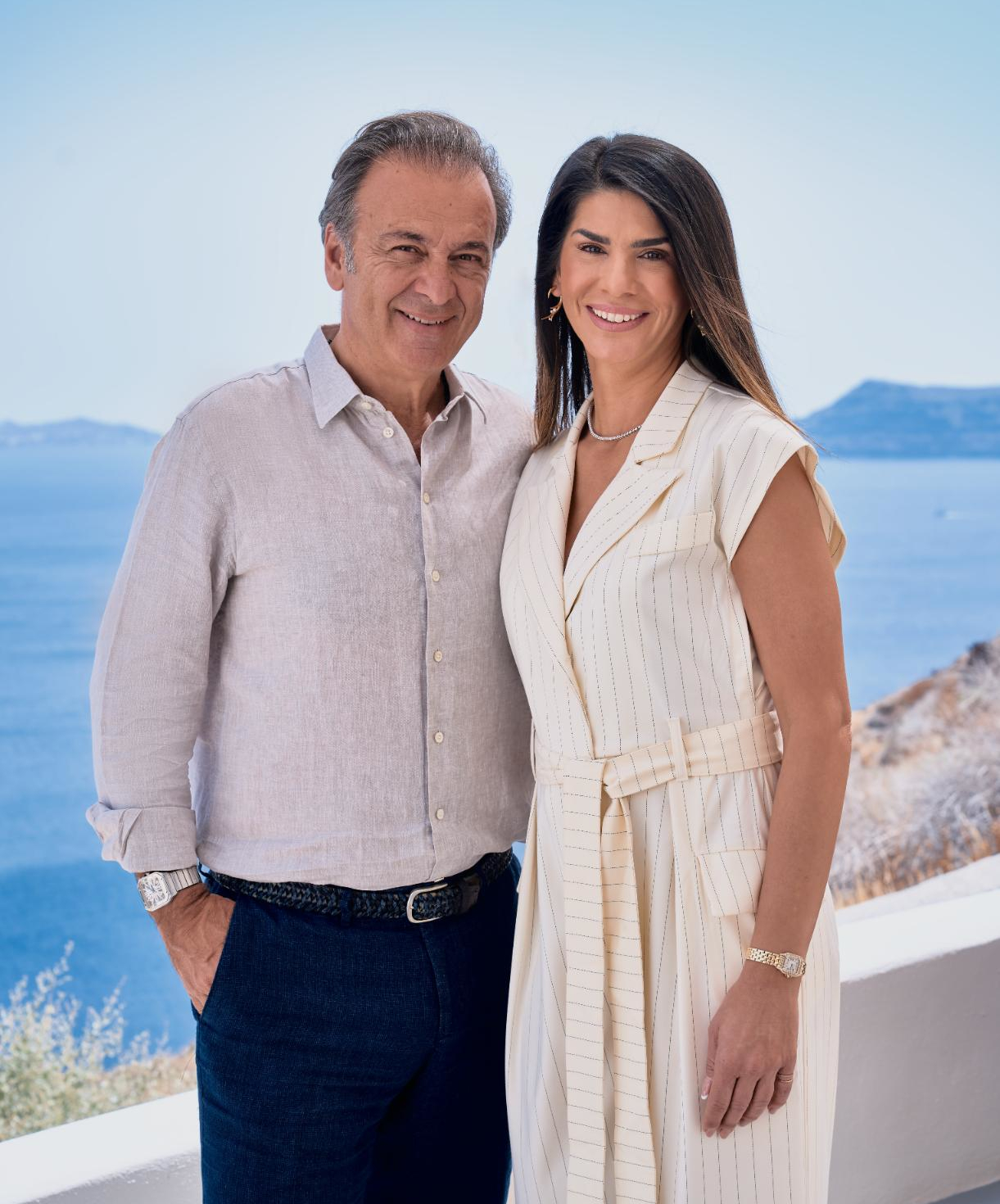 Smiling couple overlooking ocean cliffside view