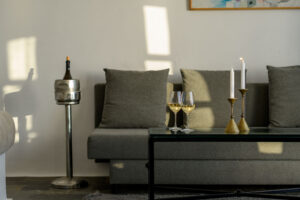 Wine glasses and candles on modern living room sofa