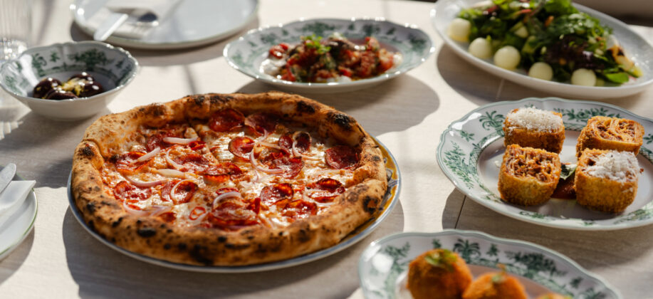 Pepperoni pizza with assorted Italian side dishes