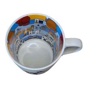 Colorful illustrated cityscape inside white ceramic mug