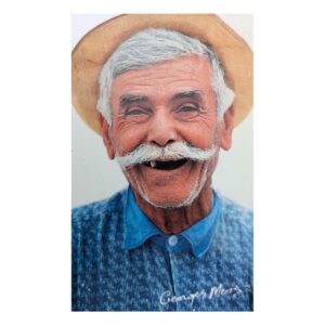 Smiling elderly man with white mustache and hat