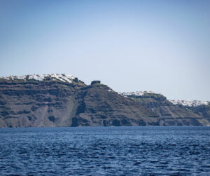 View of the caldera cliff at Imerovigli from the sea level, photos and videos