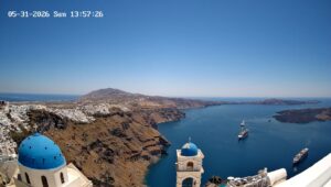 Santorini cliffs, blue domes, and cruise ships