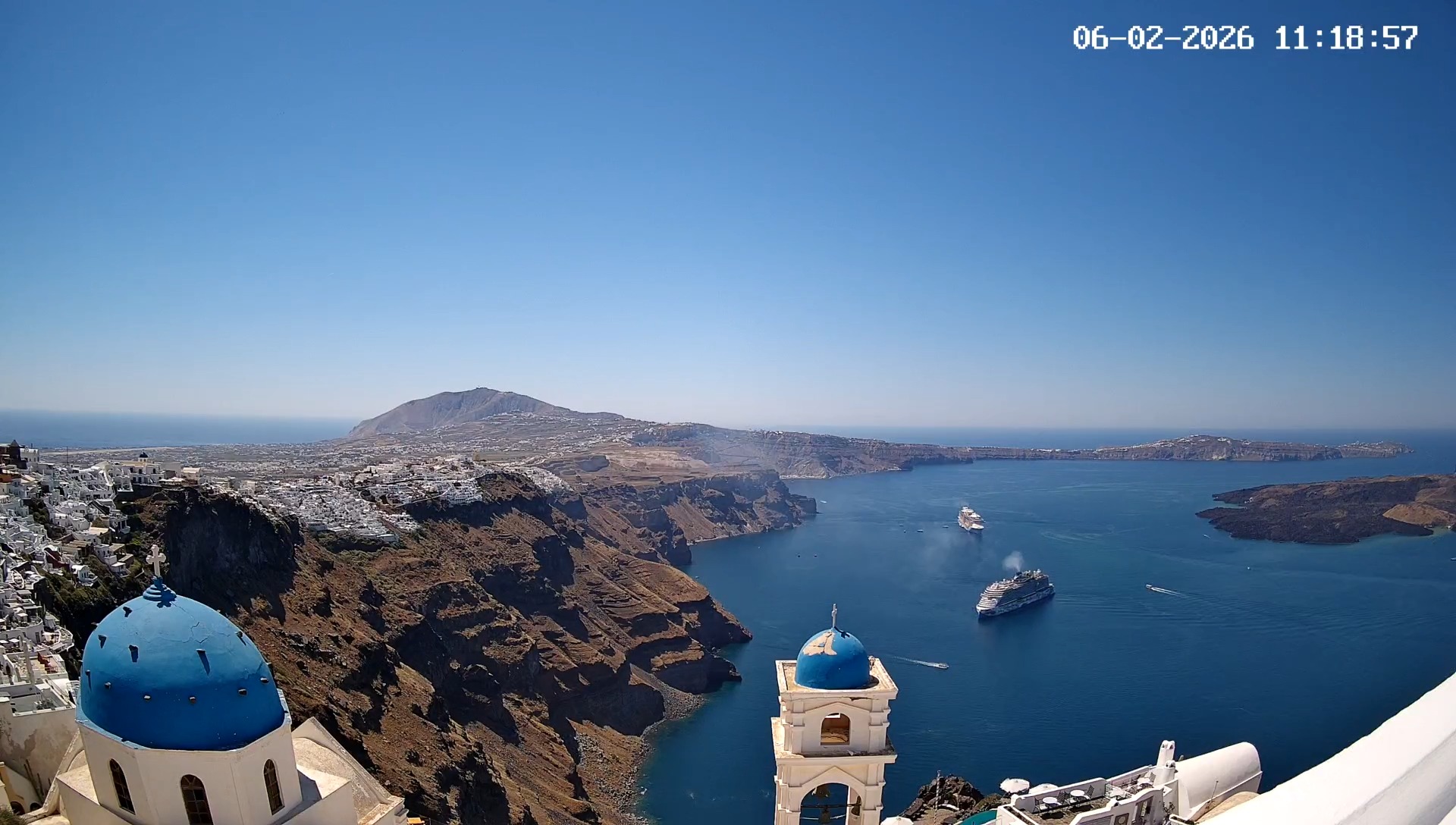 Santorini caldera with blue domes and cruise ships