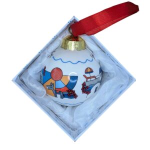 Decorative Christmas ornament in gift box with ribbon