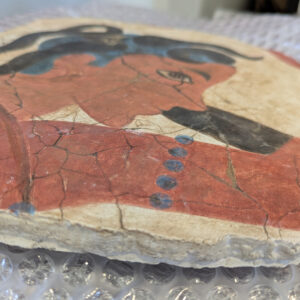 Cracked ancient fresco fragment with painted profile portrait