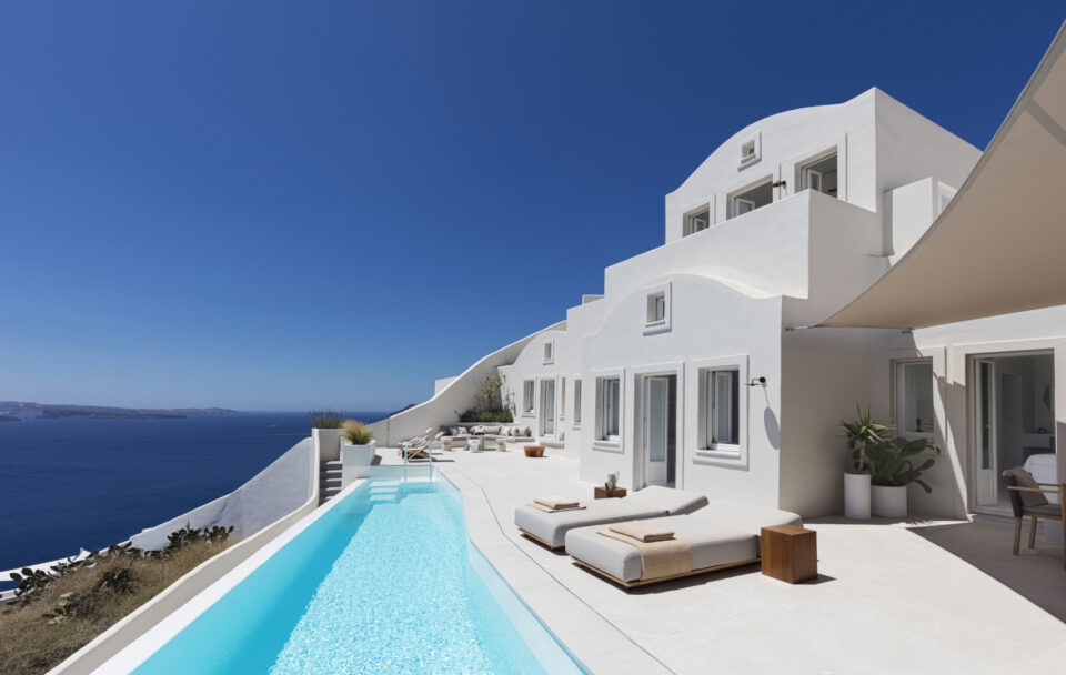 White cliffside villa with infinity pool overlooking ocean