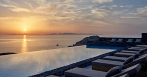 Sunset over ocean viewed from infinity pool