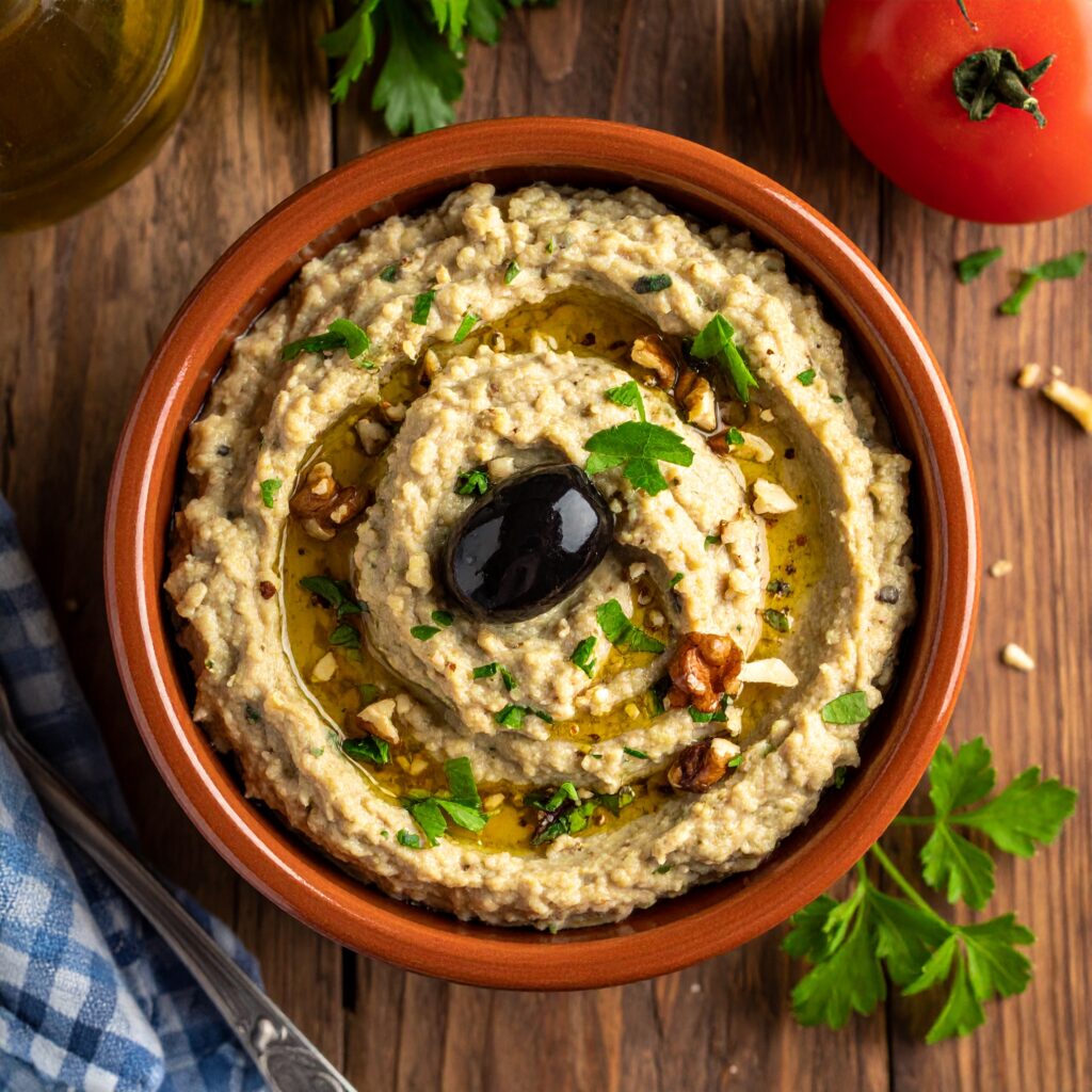 Baba ganoush with olive oil, walnuts, parsley, and olive