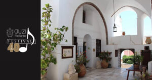 White Mediterranean courtyard with arches and potted plants
