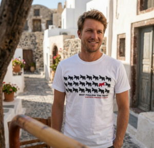 Man in Santorini alley wearing sheep graphic T-shirt