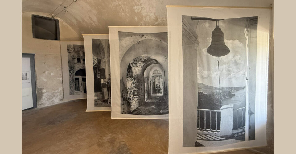 Hanging black-and-white photographs in gallery space
