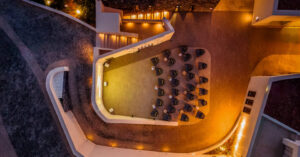 Aerial view of illuminated rooftop lounge seating at night