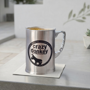 Metal mug with Crazy Donkey logo on counter