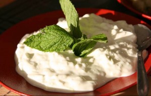 Bowl of yogurt topped with fresh mint leaves